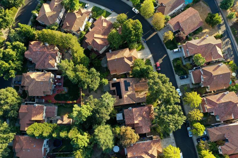 Aerial view of a mature neighborhood with red tile roofs